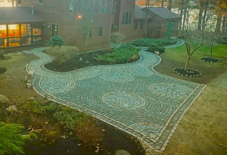 As impressive cobblestone work as you may ever see. A lot of labor went into this driveway on Little Sebago Maine. thousand of cobbles, reclaimed Belgian Stones from the streets of Portland and some quarry stone was used to produce the work of art.