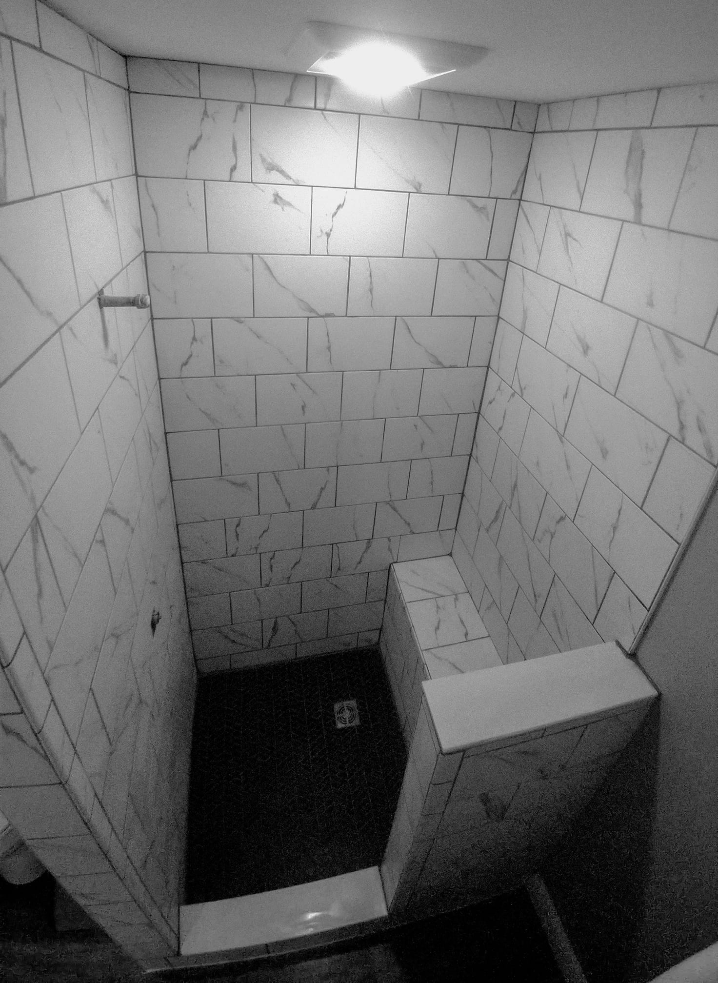 Carrera Inkjet tile was used for this small shower in pool-side changing room.