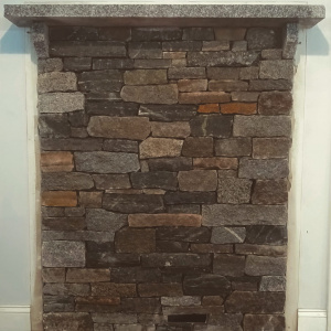 Warm and cozy is this New England style heat shield for small wood stove. The mantle was hand-split and notched from a Woodbury granite tread.