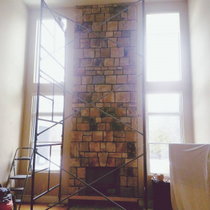 Too tall for the cameraman, this impressive fireplace surround is over 16 feet tall and made from South Bay Quartz thin-cut veneer stone. It makes a nice focal point in this great-room in Cumberland, Maine.