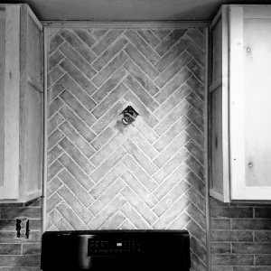 An abbey brick back-splash in a herringbone pattern 